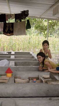 Young girls play in the small courtyard of 'Refugio Los 3 Angeles'––Olga Sánchez Martínez's second shelter specifically for families awaiting refugee status. Tapachula, Chiapas, México. Photo by Olivia Gagnon.
